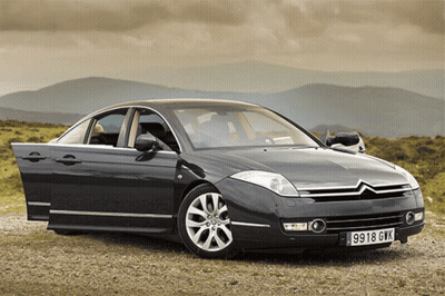 A Gray Car With The License Plate 9918 Gvk GIF