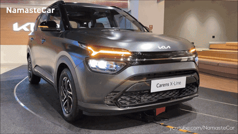 A Gray Car With The Word Carens On The Front GIF