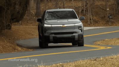 A Gray Truck Is Driving Down A Road With Motorweek.org Written On The Bottom GIF