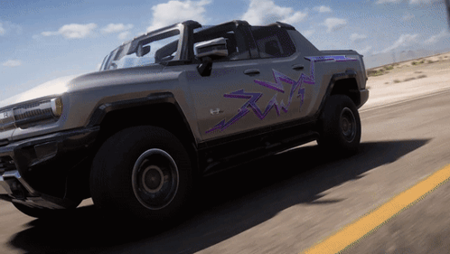 A Gray Truck With Purple Arrows Painted On The Side Is Driving Down A Road GIF