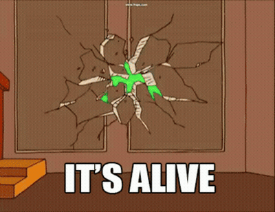 A Green Alien Is Breaking Through A Wall With The Words It 'S Alive GIF