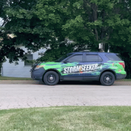 A Green And Black Suv With The Word Storm Seeker On The Side GIF