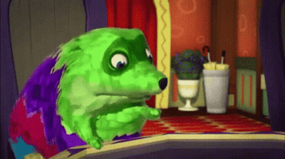 A Green And Purple Cartoon Dog Is Sitting In A Room . GIF