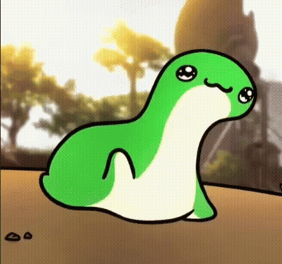 A Green And White Cartoon Frog Is Sitting On Top Of A Sandy Surface . GIF