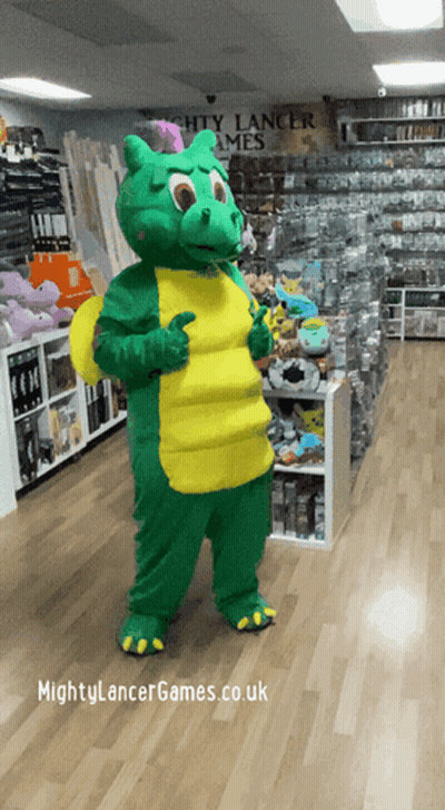 A Green And Yellow Dragon Mascot Giving A Thumbs Up In Front Of A Sign For Mighty Lancer Games GIF