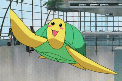 A Green And Yellow Turtle Is Flying Through An Airport Terminal GIF