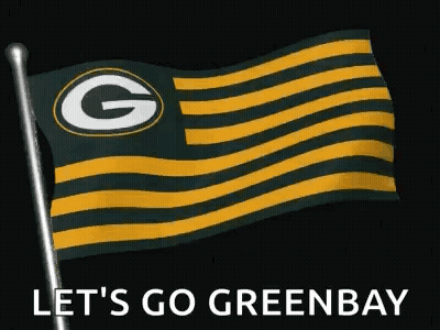 A Green Bay Packers Flag Is Flying In The Wind On A Pole . GIF
