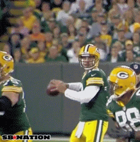 A Green Bay Packers Football Player Throws A Pass In Front Of A Crowd GIF