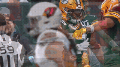 A Green Bay Packers Player Is Being Tackled By Another Player GIF