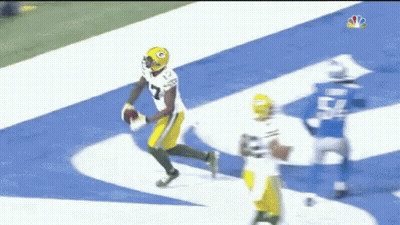 A Green Bay Packers Player Is Running With A Football GIF