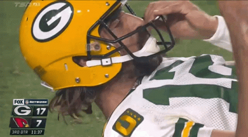 A Green Bay Packers Player Laying On The Field GIF