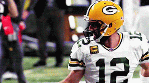 A Green Bay Packers Player Wearing A Yellow Helmet And Number 12 Jersey GIF