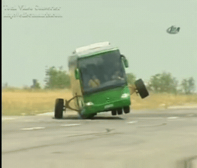 A Green Bus With A Broken Wheel Is Driving Down A Highway GIF