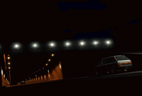 A Green Car Is Driving Through A Tunnel With A Sticker On The Windshield That Says ' Adia ' On It GIF