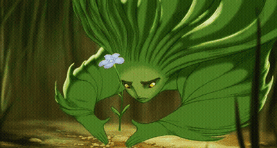 A Green Cartoon Character Is Holding A Small Flower GIF