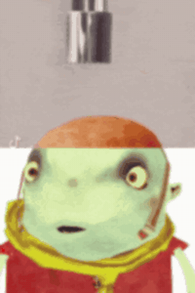 A Green Cartoon Character With A Red Hat And Scarf Looks Surprised GIF