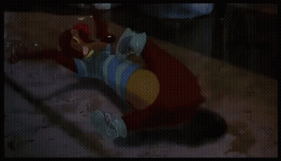 A Green Cartoon Character With Wings Is Laying On The Floor . GIF