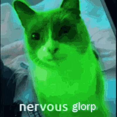 A Green Cat Is Sitting On A Bed With The Words `` Nervous Glorp '' Written On It . GIF