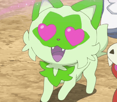 A Green Cat With Pink Heart Shaped Eyes And A Green Leaf On Its Face GIF