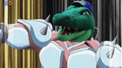A Green Crocodile Wearing A Blue Hat And White Armor GIF