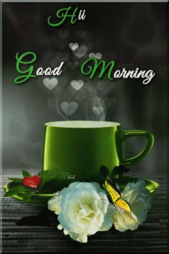 A Green Cup Of Coffee Sits On A Saucer Next To Flowers GIF
