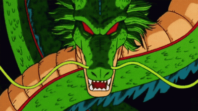 A Green Dragon With Red Eyes And Sharp Teeth Looks At The Camera GIF