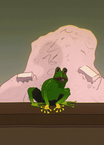 A Green Frog With Yellow Claws Sits On A Table GIF