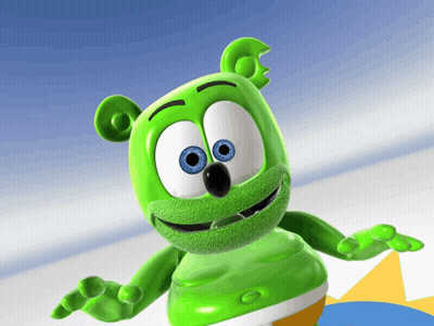 A Green Gummy Bear With Blue Eyes Is Standing In Front Of A Blue Background GIF