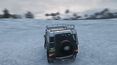 A Green Land Rover Driving Through The Snow GIF