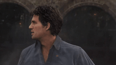 A Green Leaf Is Floating In A Dark Room GIF