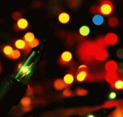 A Green Light Is Lit Up In Front Of A Bunch Of Colorful Lights GIF