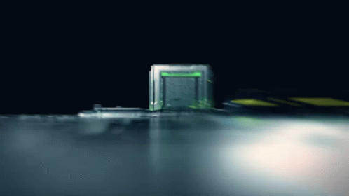 A Green Light Is Shining On A Dark Background GIF
