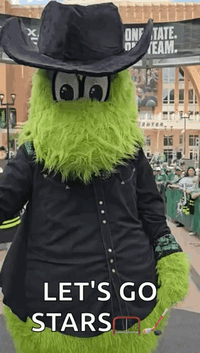 A Green Mascot Is Wearing A Cowboy Hat And A Black Shirt And Says Let 'S Go Stars . GIF