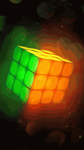 A Green Orange And Yellow Rubik 'S Cube In A Dark Background GIF