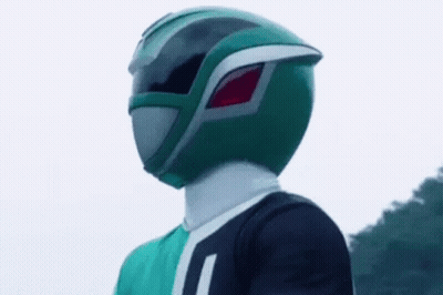 A Green Power Ranger Is Wearing A Green Helmet And A Green Shirt . GIF