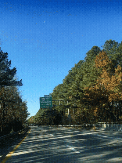 A Green Sign On The Side Of A Highway Shows The Directions To Strawberry GIF