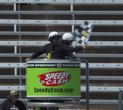 A Green Speedy Cash Sign With Two People In It GIF