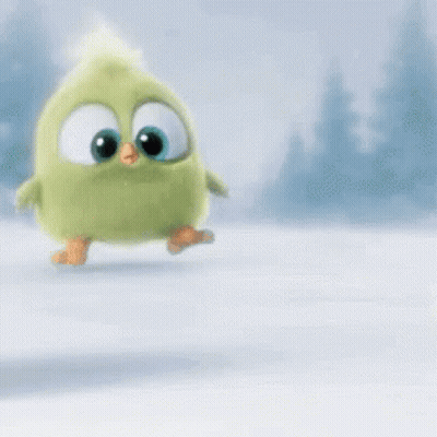 A Green Stuffed Animal With Big Eyes Is Walking In The Snow . GIF