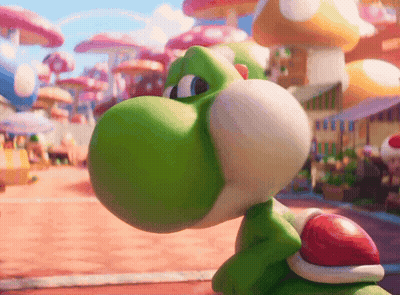 A Green Toy With A Red Shell On Its Back Is Looking At Something GIF