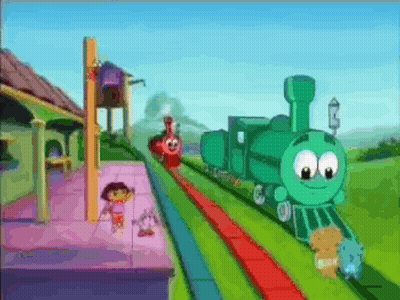 A Green Train With A Face On It Is Going Down A Train Track GIF