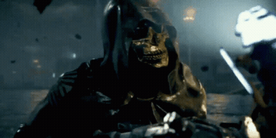 A Grim Reaper With A Skull On His Face Is Holding A Sword GIF