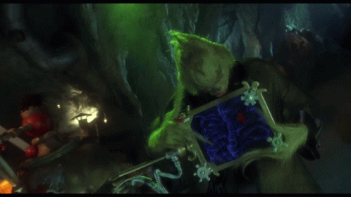 A Grinch Holding A Shield With The Words Down A Size And A Half GIF
