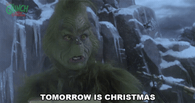 A Grinch Says Tomorrow Is Christmas In Front Of A Snowy Mountain GIF