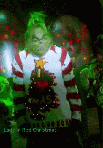 A Grinch Wearing A Christmas Sweater With The Words Lady In Red Christmas On The Bottom GIF