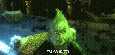 A Grinch With Green Hair Is Sitting In A Chair And Saying I 'M An Idiot GIF