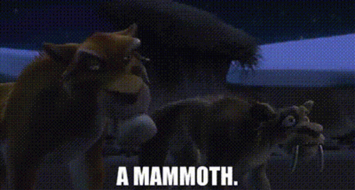 A Group Of Animals Standing Next To Each Other In A Field With The Words `` A Mammoth '' Written On It . GIF