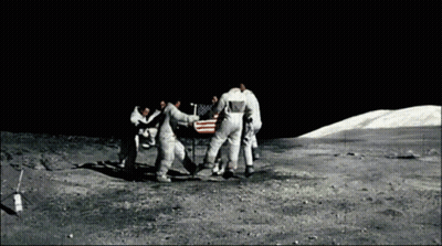 A Group Of Astronauts Are Standing Around An American Flag On The Moon GIF