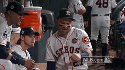 A Group Of Astros Players Are Sitting In The Dugout GIF