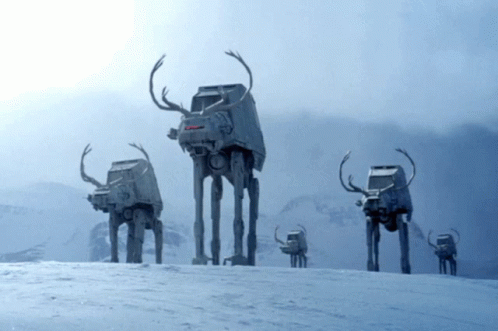 A Group Of At At Walkers With Antlers On Their Heads GIF