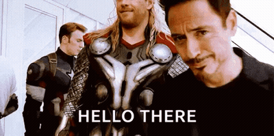 A Group Of Avengers Are Standing Next To Each Other And A Man Is Standing In The Middle Of The Group . GIF